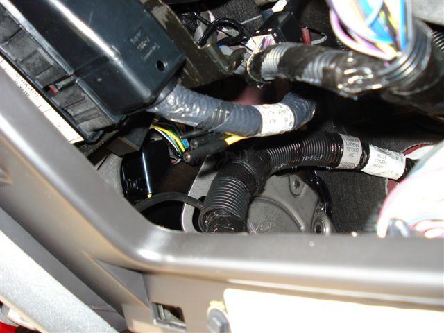 pass-thru wires, are bundled together at the harness above the parking brake pedal assembly behind the data link connector.