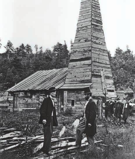 This 1861 photograph shows Edwin Drake (foreground, top hat) at the original 1859 Drake oil well in Titusvile, Pennsylvania, the first commercial oil well drilled in the United States.