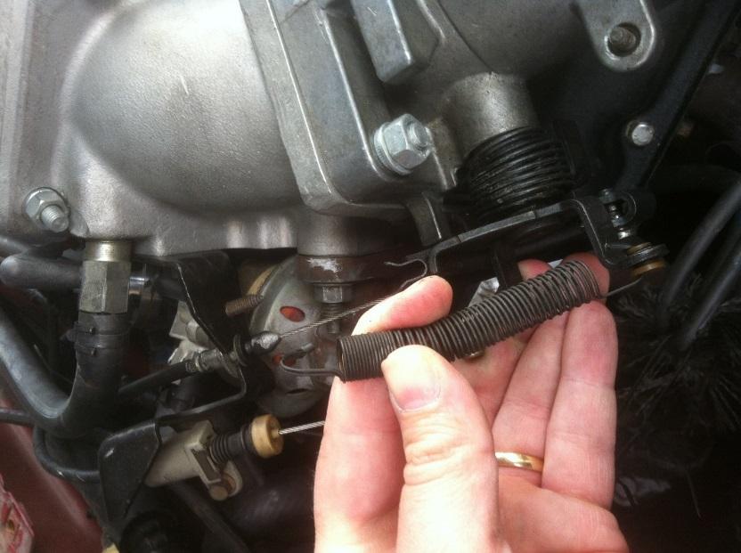 6) Unhook throttle return spring and set aside, be sure to keep