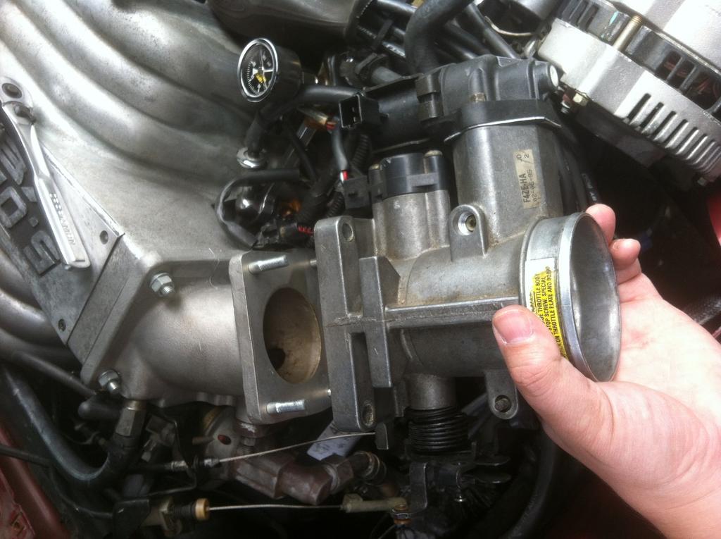 11) Once the nuts are removed, slide the throttle body off of the intake manifold, if stuck then using