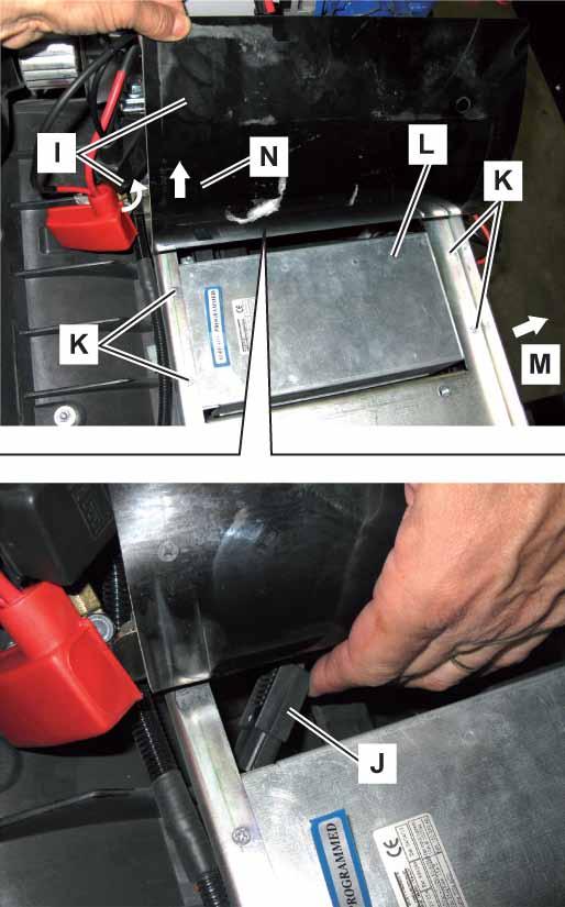 Electrical and Control System 81 Battery Charger Removal/Installation (SW900 B) (Continues) 7. Lift the rubber mat (I) in the battery compartment. 8. Disconnect the battery charger electrical connector (J).