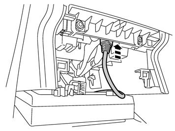 15 Lift up the tunnel console at the trailing edge and pull up the connector from the hole in the trailing edge of the storage compartment.