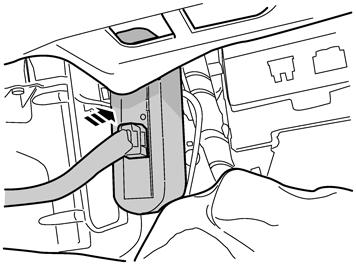 right-hand side of the centre console. Fold back the carpet. Note! Do not damage the fibre optic cable.