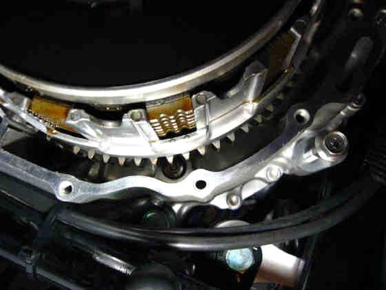 11. Remove the 6 hex head bolts in stages and in crisscross pattern from and the clutch spring plate retainer (1) [10mm socket] 12.