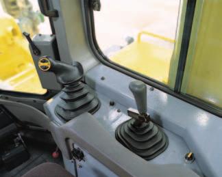 seat 15 to the right. The transmission and steering controls move with the seat for best operator comfort. The operator seat is also tiltable for facilitating downhill dozing.