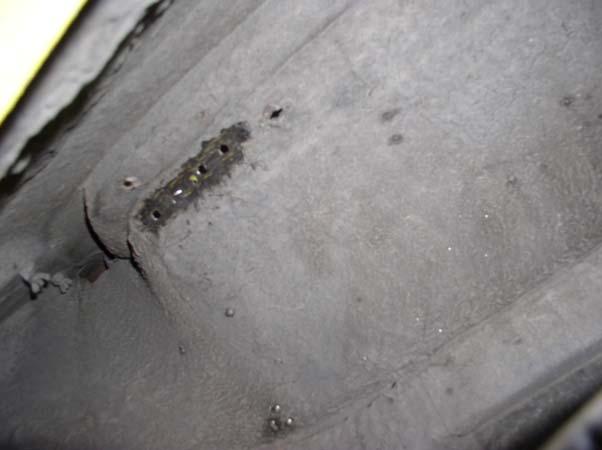 6) Scrape off the undercoating in the wheel well so that the nut plate bracket will