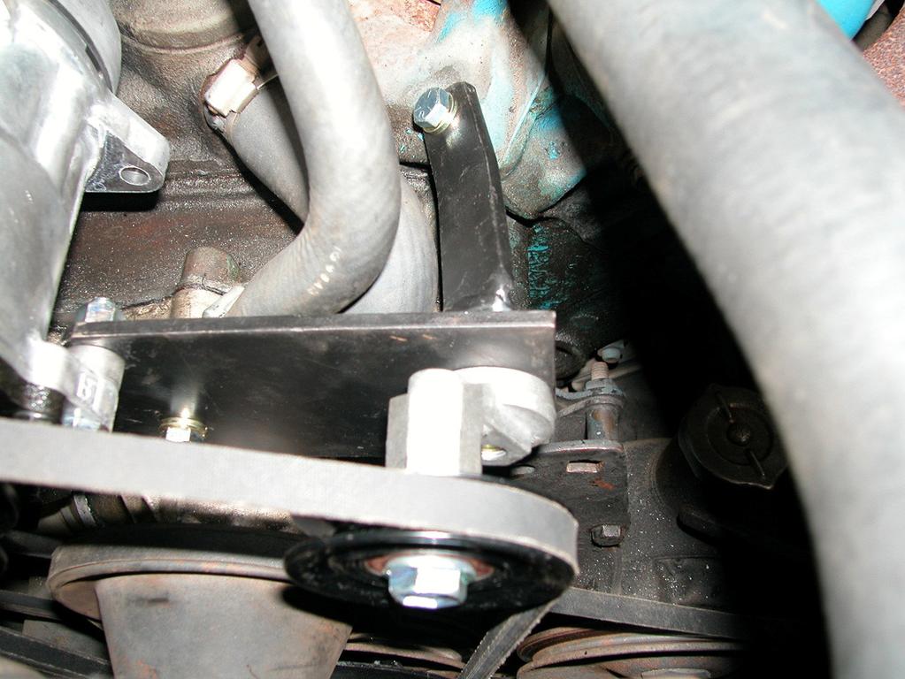 Notice rear compressor support bar, spacer and bolt thru rear alternator mount into cylinder head.