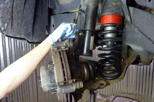 Step 57 Align the upper hole in the steering knuckle with the hole in the strut and