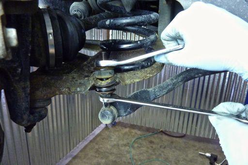 the sway bar link using a 14 mm box end wrench on the nut and a 14 mm