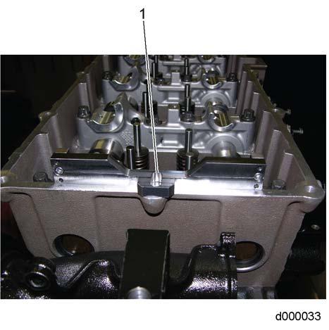 Install camshaft timing tool (W470589034000) (1) to the front of the camshaft frame and into the grooves cut into the camshafts. Secure timing tool to the camshaft with a bolt.