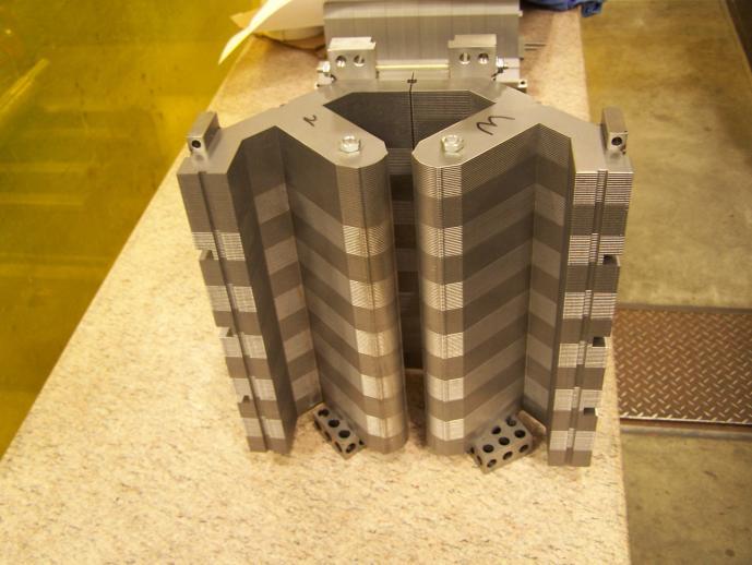 The coil design for the QR quadrupole however, was an entirely new design, with inner and outer cooling plates, which required manufacturing.