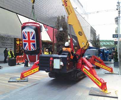 lifting a Mini for a display Kevin Conception with hire manager Jade Burton. its distinctive yellow and red livery.