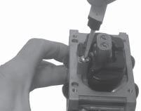 . Attach the inlet needle to the plastic tang of the float with the wire clip. The formed 90 lip should point up, with the needle valve hanging down. See Figure -18. 7.