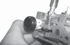 Figure -28. Installing Idle Speed Adjusting Screw and Spring. 12. Attach the inlet needle to the plastic tang of the float with the wire clip.
