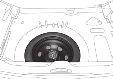 Practical information Access to the spare wheel Wheel with trim When removing the wheel, first detach the trim using the wheelbrace 1 pulling at the valve passage hole.
