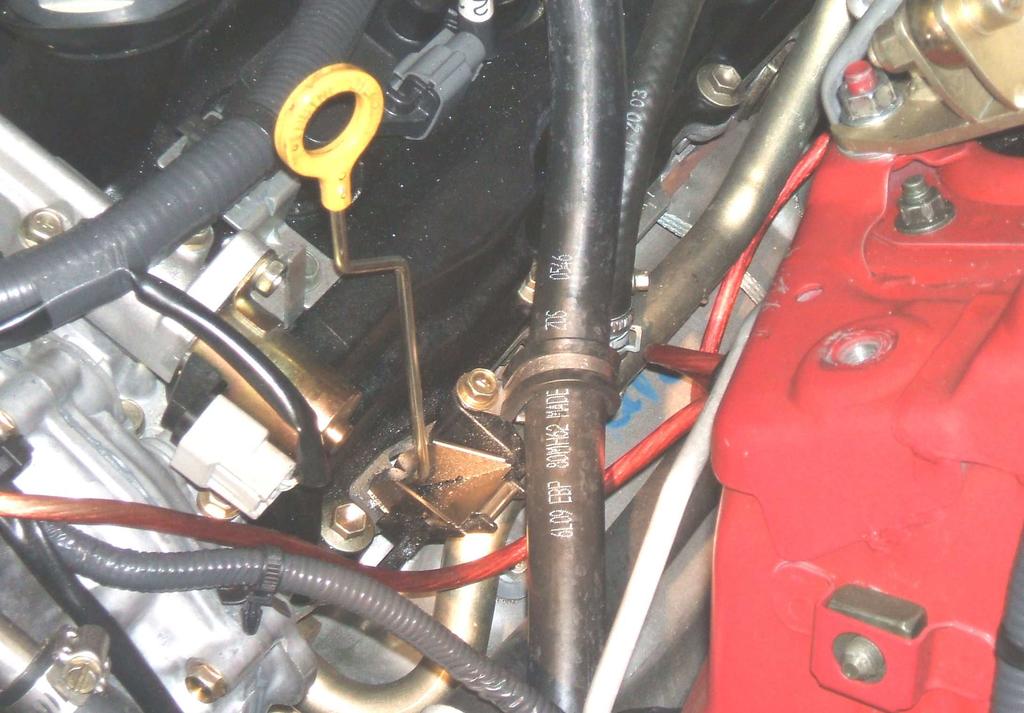 Cut a piece of ¾ heater hose approximately 30 and route it to the inlet of the water pump (bottom fitting). Route this hose into the engine compartment as shown in PHOTO 32. 6.