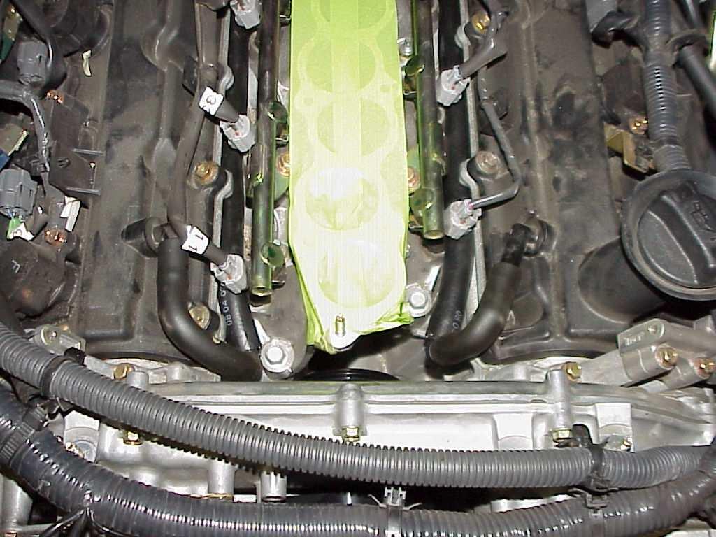 14. Next you will be replacing the crankcase breather hose that runs between the 2 valve covers (PHOTO 9).