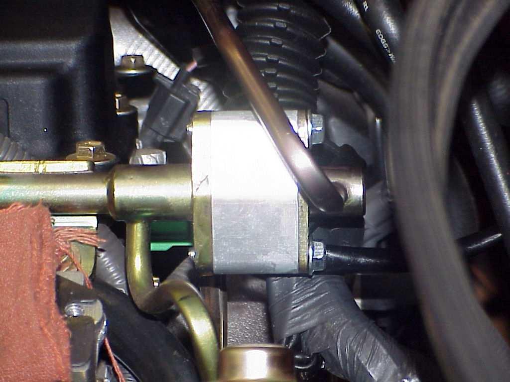 17. Install the lower tensioner assembly onto the just installed drive unit. Use the three supplied M12x50MM flat SHCS and torque to 40 ft-lbs. (PHOTO 13). 18.