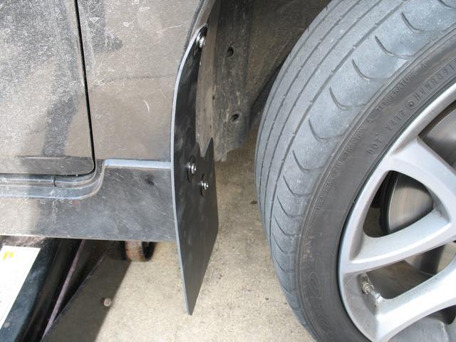 8. Install the front right mud flap with the textured side facing the rear of the vehicle using the 3 bolts and washers.