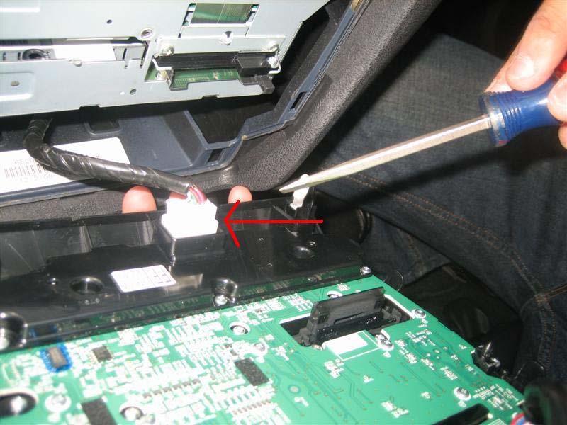 c. Using your finger or flat head screw driver, disconnect the connector that is on the bottom right side on the back of the radio panel.