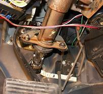 Loosen two lower mounting bolts or nuts and