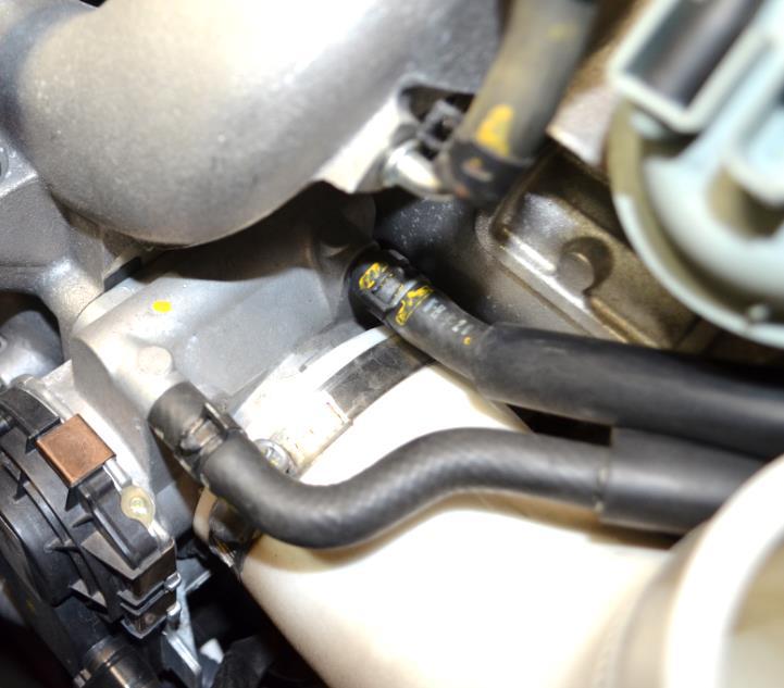 Figure 4a c) Remove the throttle body inlet hose using a 10mm socket wrench. Shown with the blue circle in Figure 4a.