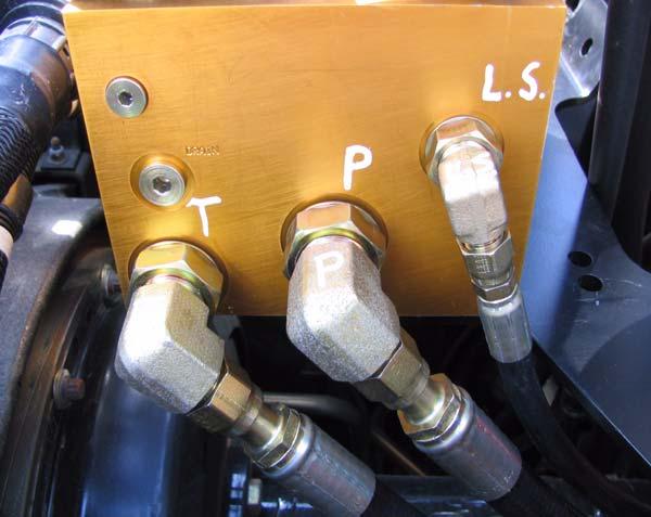 Hydraulic Hose Connection Procedures 5. Connect the other end of the hose to the Pressure port (P) under the Steering Valve. See Figure 2-12. Figure 2-12 Steering Valve Ports Connections 6.