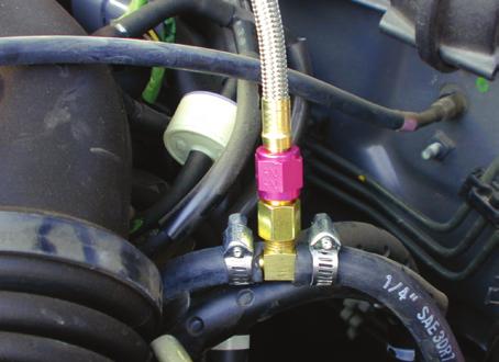 1. Located on the fuel log (injector rail) is a test port fitting used by mechanics for checking fuel pressures.