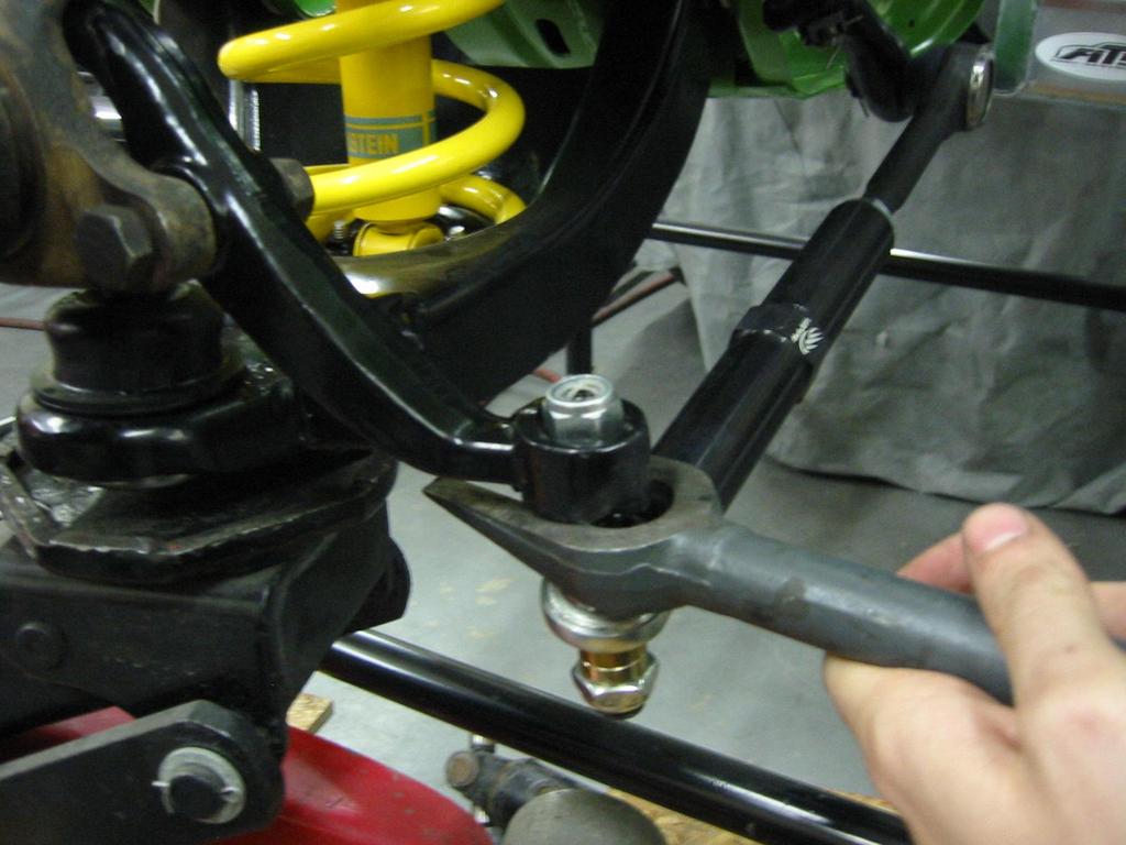 2. Loosen the castle nuts and using the pickle fork repeat the process for breaking loose the upper and lower ball joints.