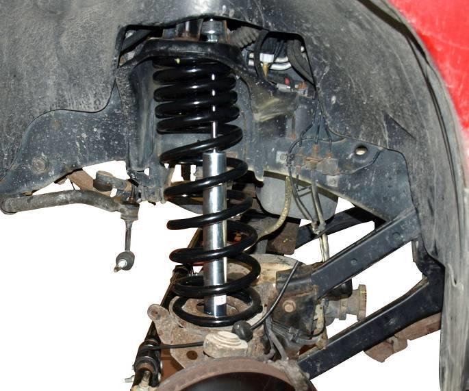 6) Remove the lower bolt from the axle bracket. See illustration 5. Remove the shock absorber from the engine compartment. Illus. 6 7) Mark the coil spring and axle pad for installation reference.