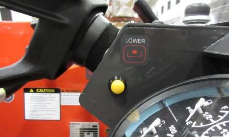 Once the pushbutton is held the operator may lower the hopper using the manual lever of the main spool valve.