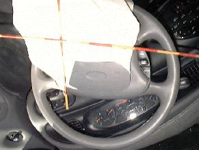 The circular air bag was equipped with four tether straps and two vent ports. Some evidence of scuffing/occupant contact was found on the air bag.