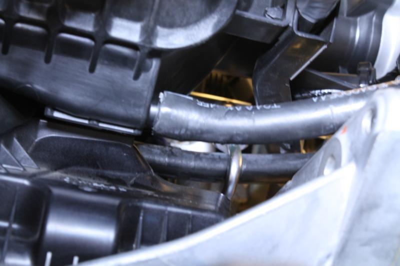 Page17 26. Route the stretched end of the hose in from the driver s side, below the lower radiator hose, towards the port on the intake manifold.