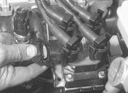 Engine removal and overhaul procedures 2D 11 5.11 Unbolt the engine/transmission-tobody earth lead from the transmission 5.14a Disconnect the wiring multi-plug from the ignition coil... 5.14b.