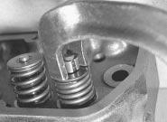 Take care not to damage the valve stem with the compressor, and do not overcompress the spring, or the valve stem may bend.