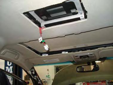 3. Pull harnesses above headliner exiting sunroof opening, then route around driver side of sunroof opening exiting monitor