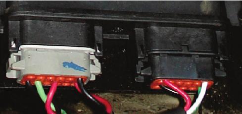 The route through the firewall is located on the driver s side, here In order to run the valve cable through the firewall you must remove the wedge from the connector by using a standard flat blade