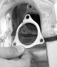 Cylinder System 15. Install a new gasket (23) as shown. 16. Install the exhaust pipe joint (24) with the flat facing (25) down. 17.