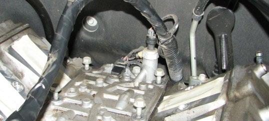 Use a 27mm wrench to remove the oil pressure sensor from the valley tray. 54.