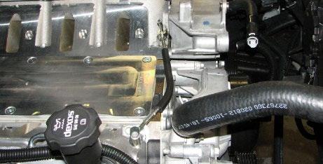 Using a razor blade or equivalent, remove the rubber guard on the factory coolant crossover and install it onto the
