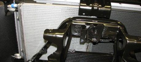 96. Gently pull the front A-frame brace assembly forward and carefully slide in the Low Temp Radiator (LTR) through the passenger side. 99.