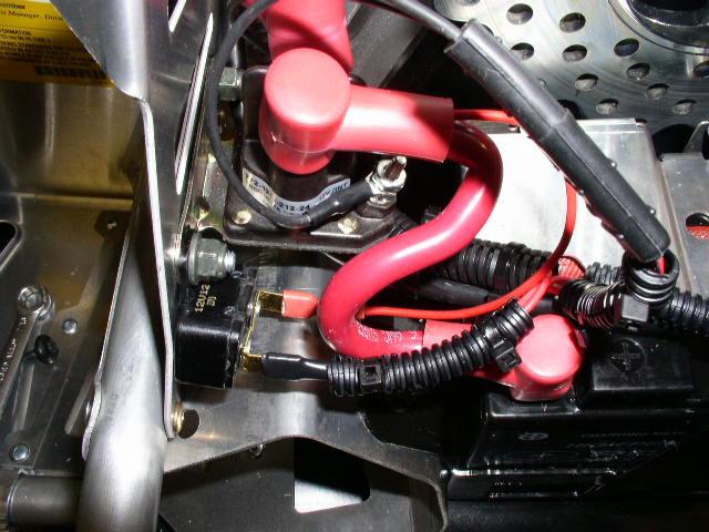 Tie both battery cables and e-start harness (PN 2411513) to upright tube using cable tie around tape mark. Figure 12.