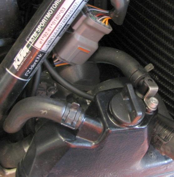 7. Pull the engine holder forward as shown in picture 7 between the manifold and the