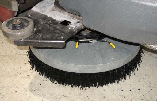 MAINTENANCE SIDE BRUSH (OPTION) 2. Squeeze the spring handles and let the side brush drop to the floor.