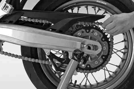 13 WHEELS, TIRES 100 Push the rear wheel forwards as far as possible and take the chain off the rear sprocket. Danger of accidents Reduced braking effect caused by damaged brake discs.