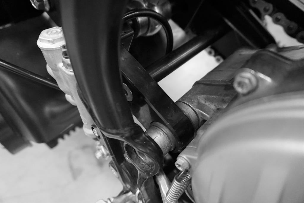 Lift the kit from both sides using two people and slide the swingarm mounts and collars into the swingarm axle location, secure using the stock greased