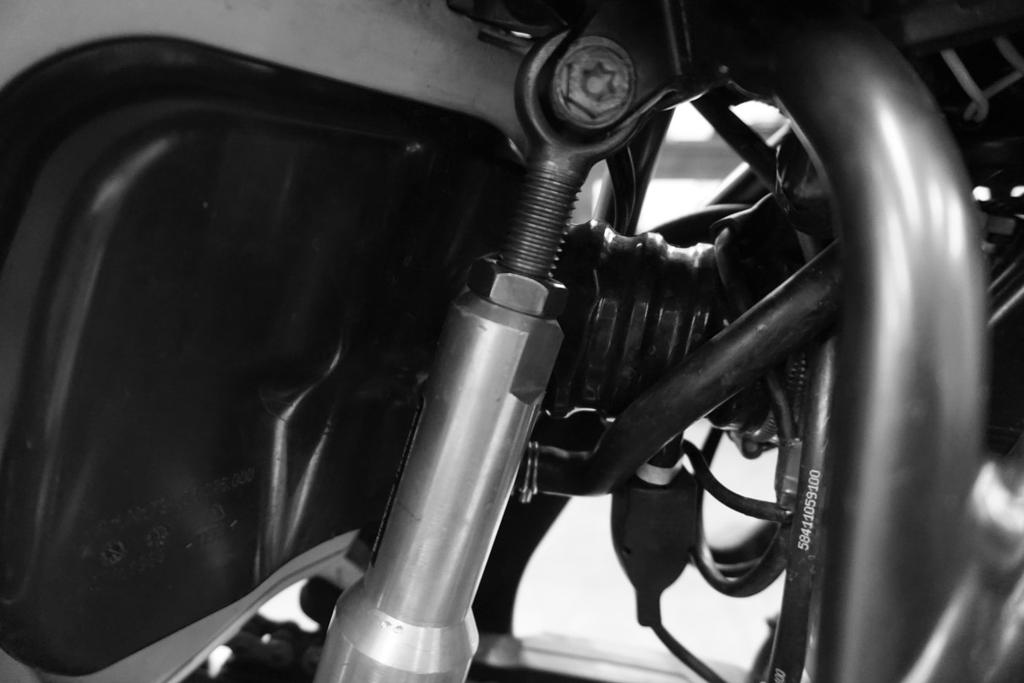 Mount the strut into the upper shock hole as shown, torque bolt to OEM specs. Install the front link bolts (TD) and torque to specs below.