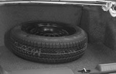 Storing the Flat Tire and Tools CAUTION: Storing a jack, a tire or other equipment in the passenger compartment of the vehicle could cause injury.