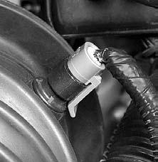 Remove the air intake hose that is snapped over the throttle body by pulling the hose upward and away from the throttle