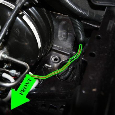 Pass the red wiring through one of the existing access points (one is located on the driver s side firewall). Be sure to ensure the wires are not pinched or pressing against a sharp metal edge.